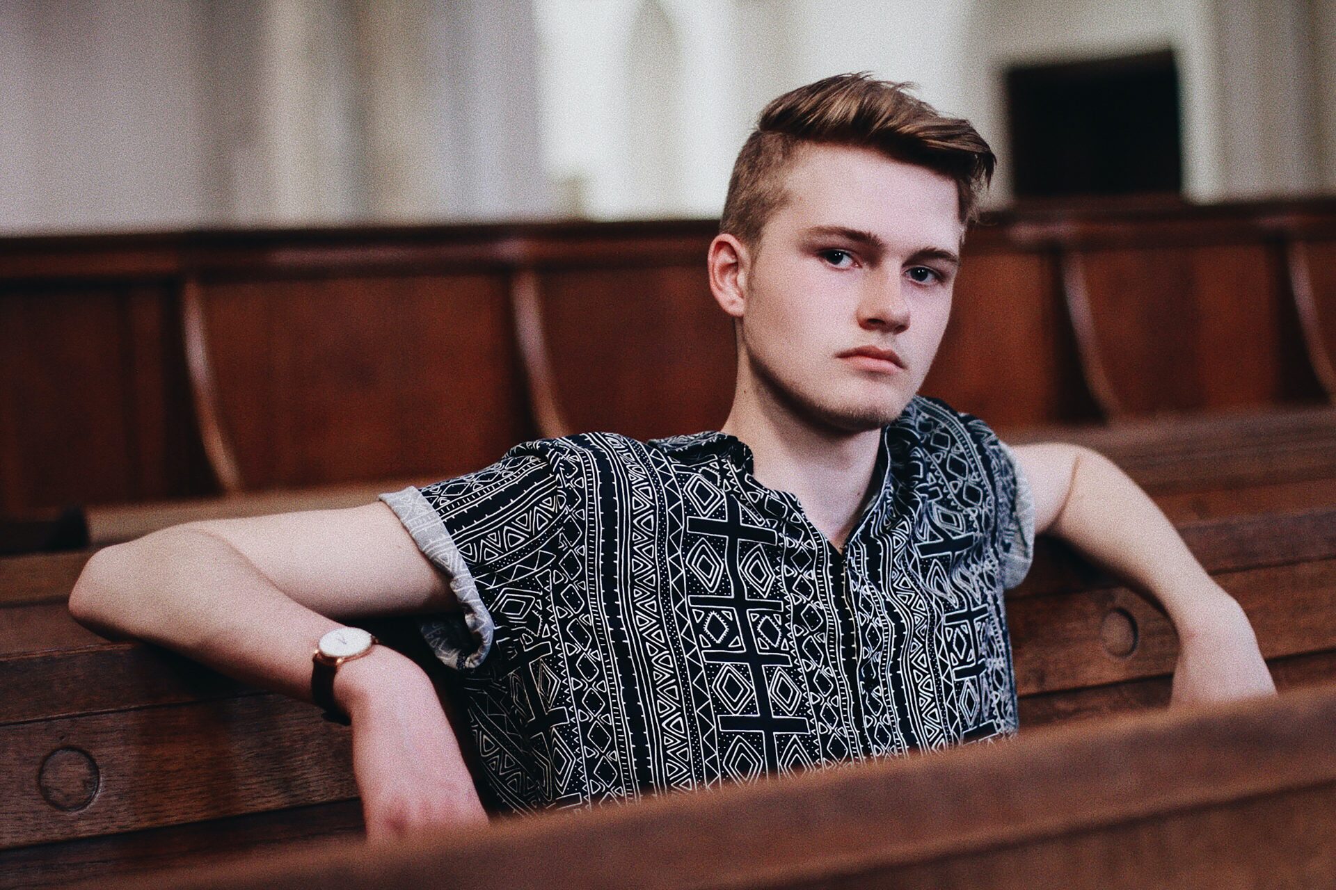 man sitting in a pew in church