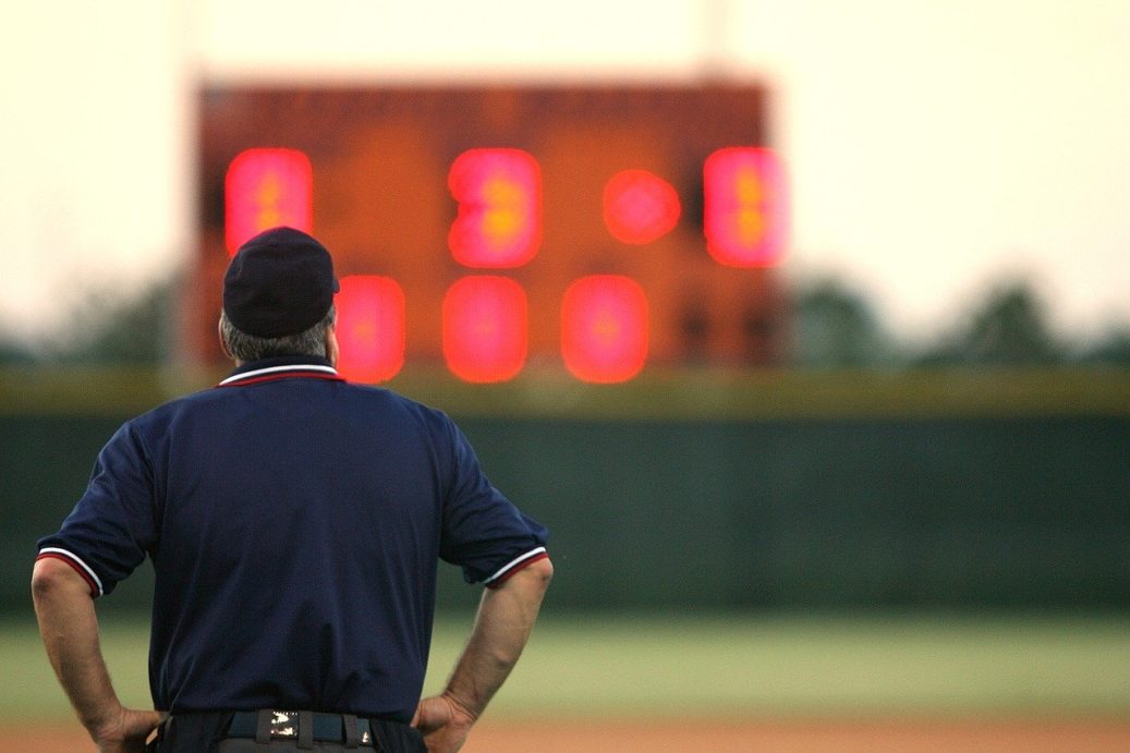 umpire looking at score board