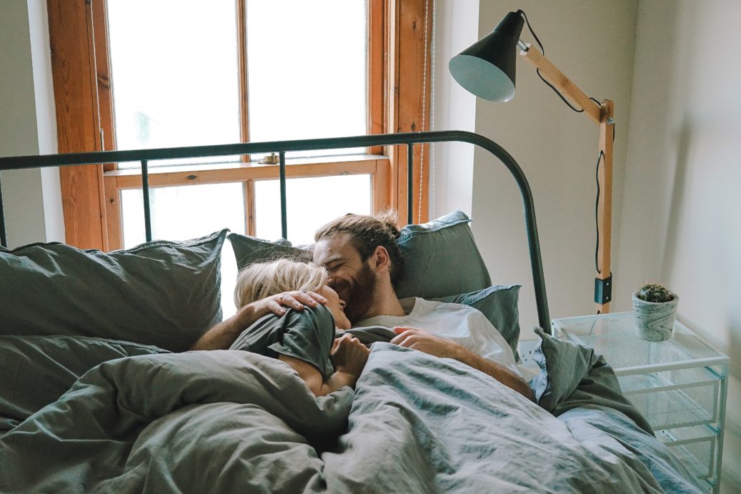 couple snuggling in bed