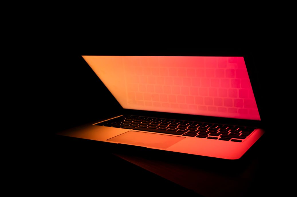 laptop in dark with red screen