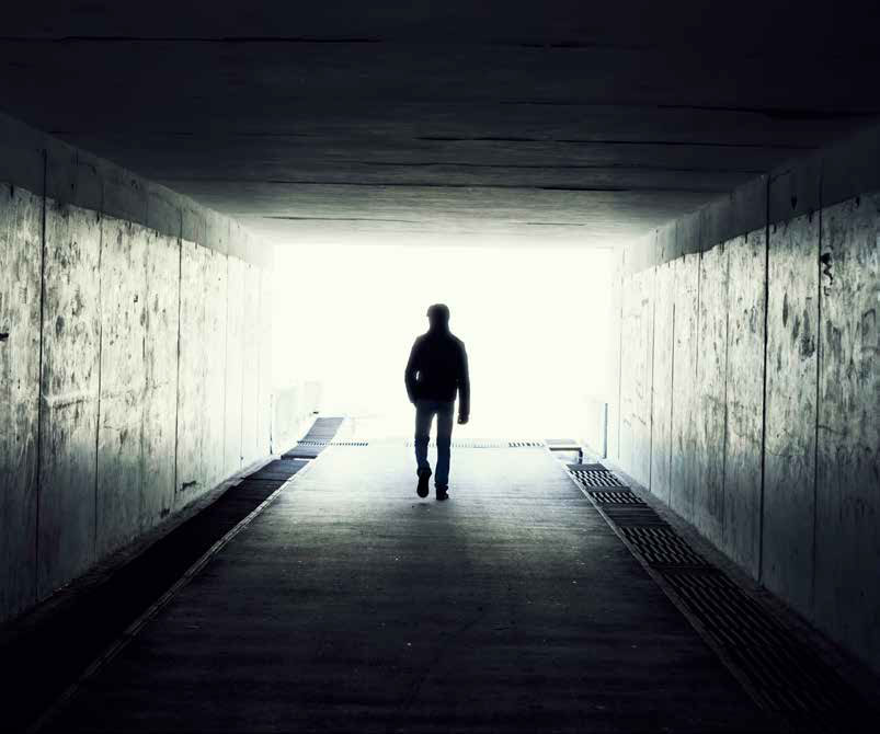 man walking in tunnel