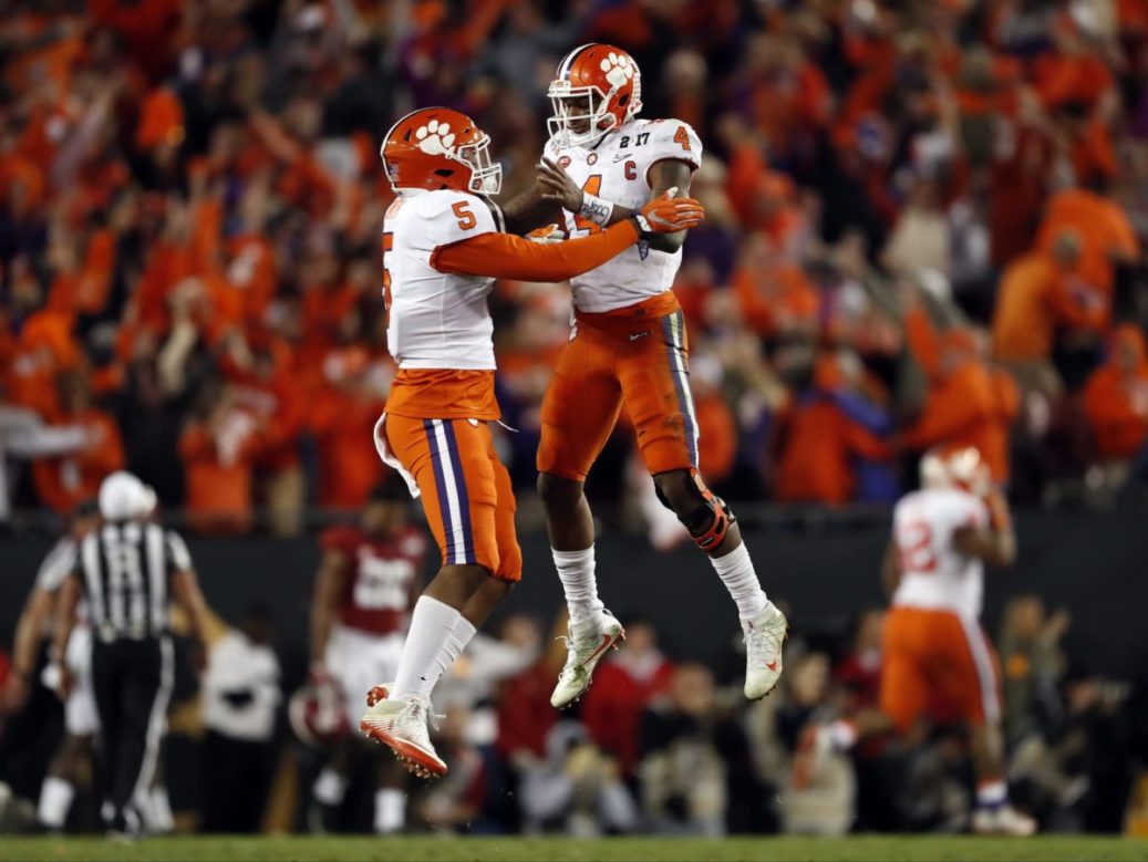 football players jumping toward each other in the air