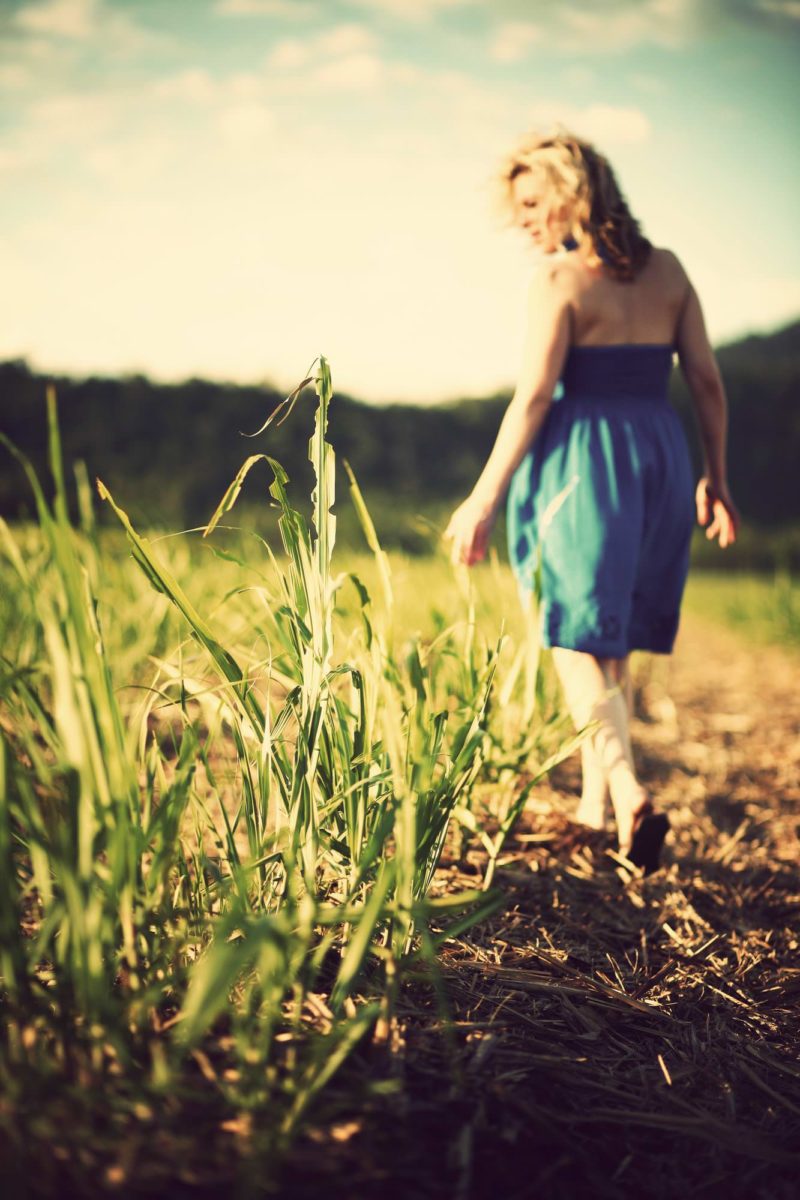 woman walking through field