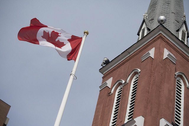 steeple of church with Canadian flag