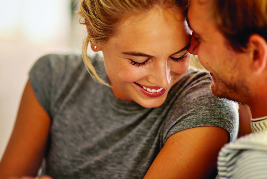 husband and wife smiling to each other