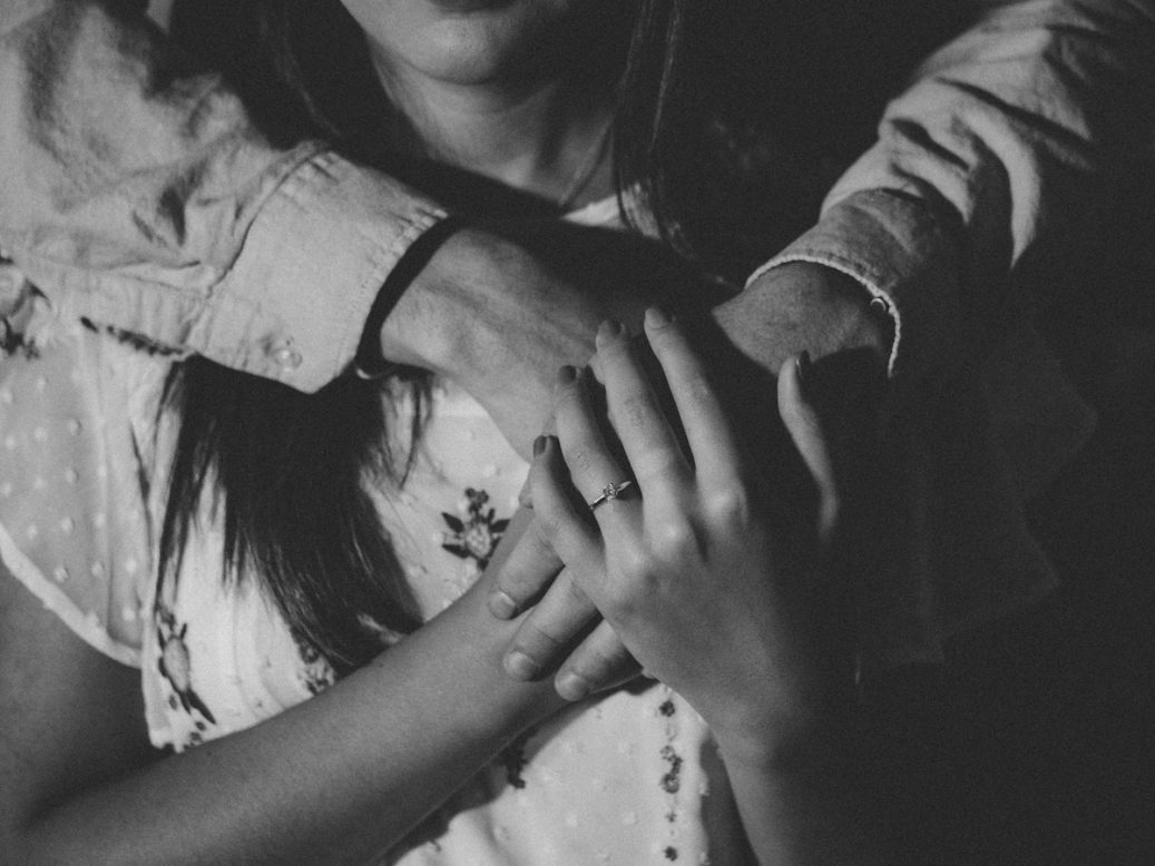 father holding daughter and daughters hands on top of fathers