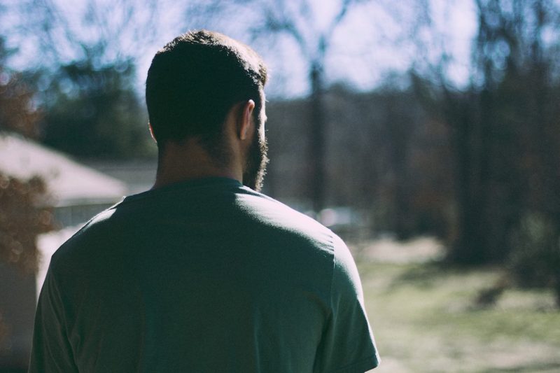 man looking into backyard