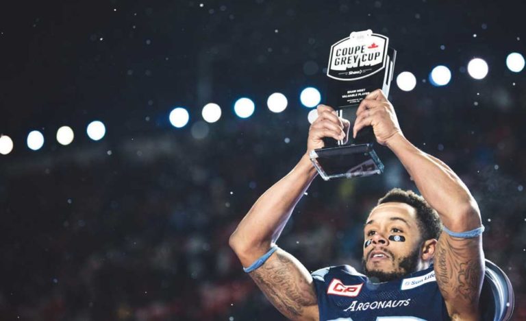 argos player holding grey cup