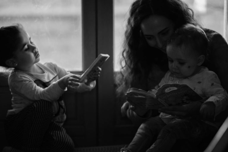 mom holding kids - black and white