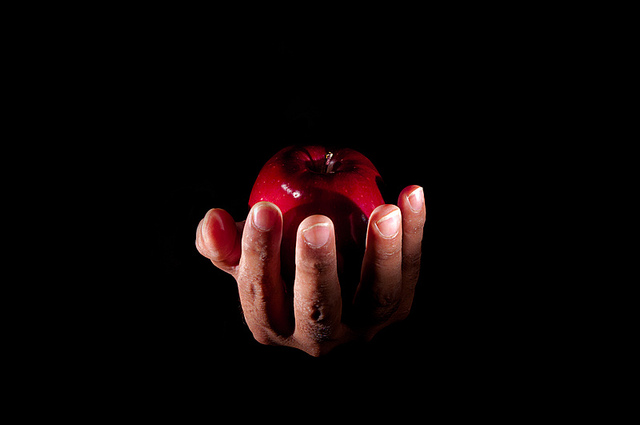 hand offering an apple