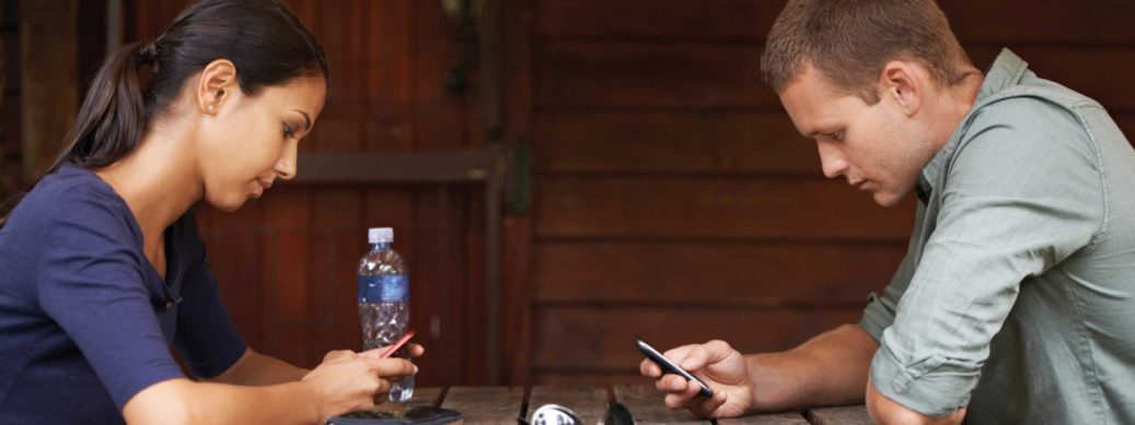 man and woman on their phones