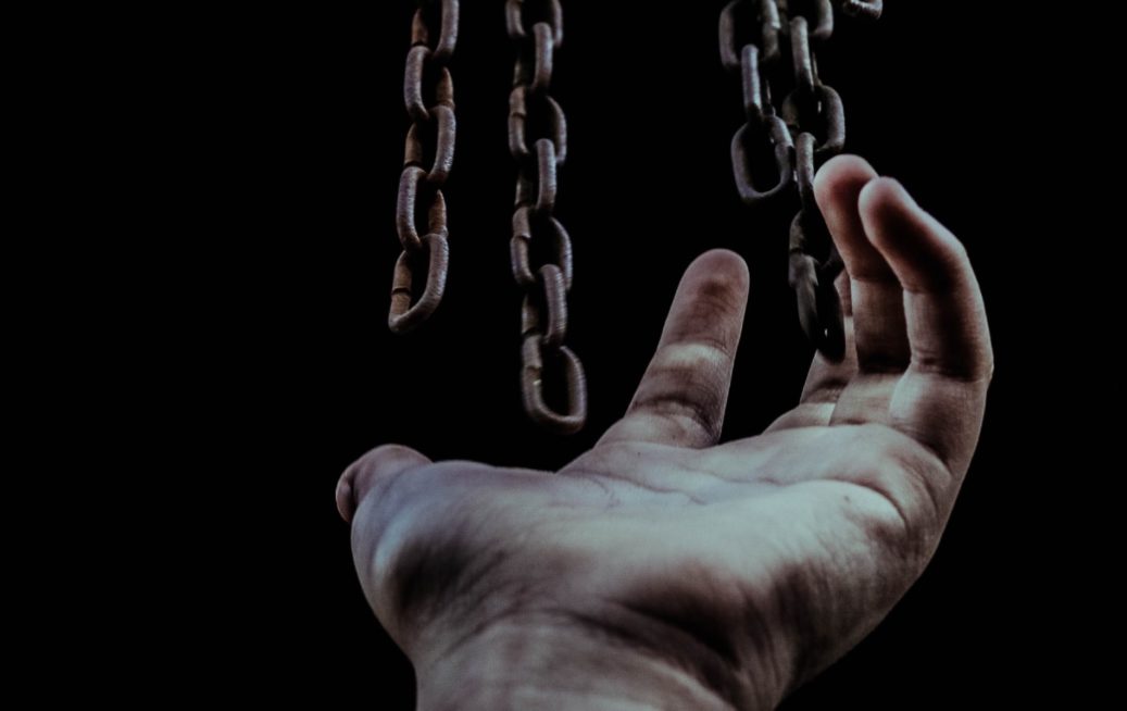 chains hanging over a hand