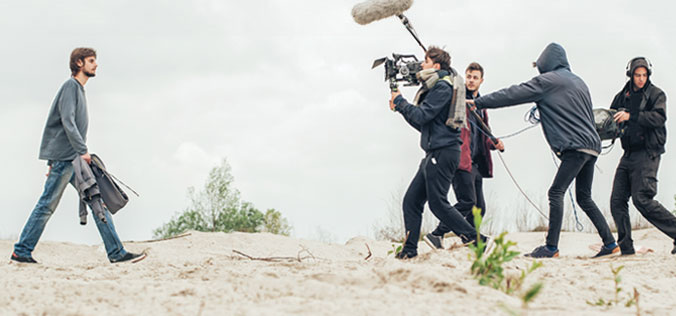 film crew filming a man walking