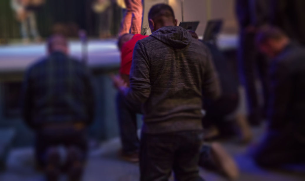 man kneeling down praying