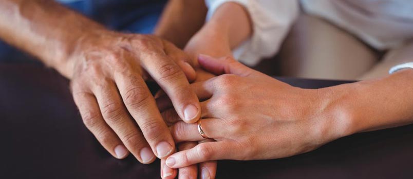 couple's hands wedding band