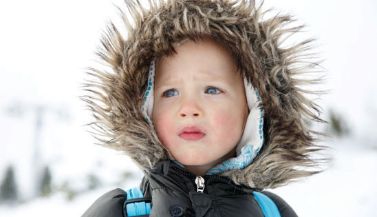 child in a fur lined parka