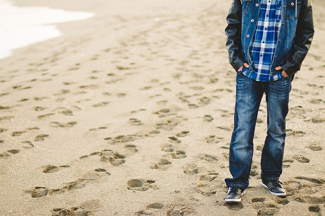 man on beach with lots of footprints