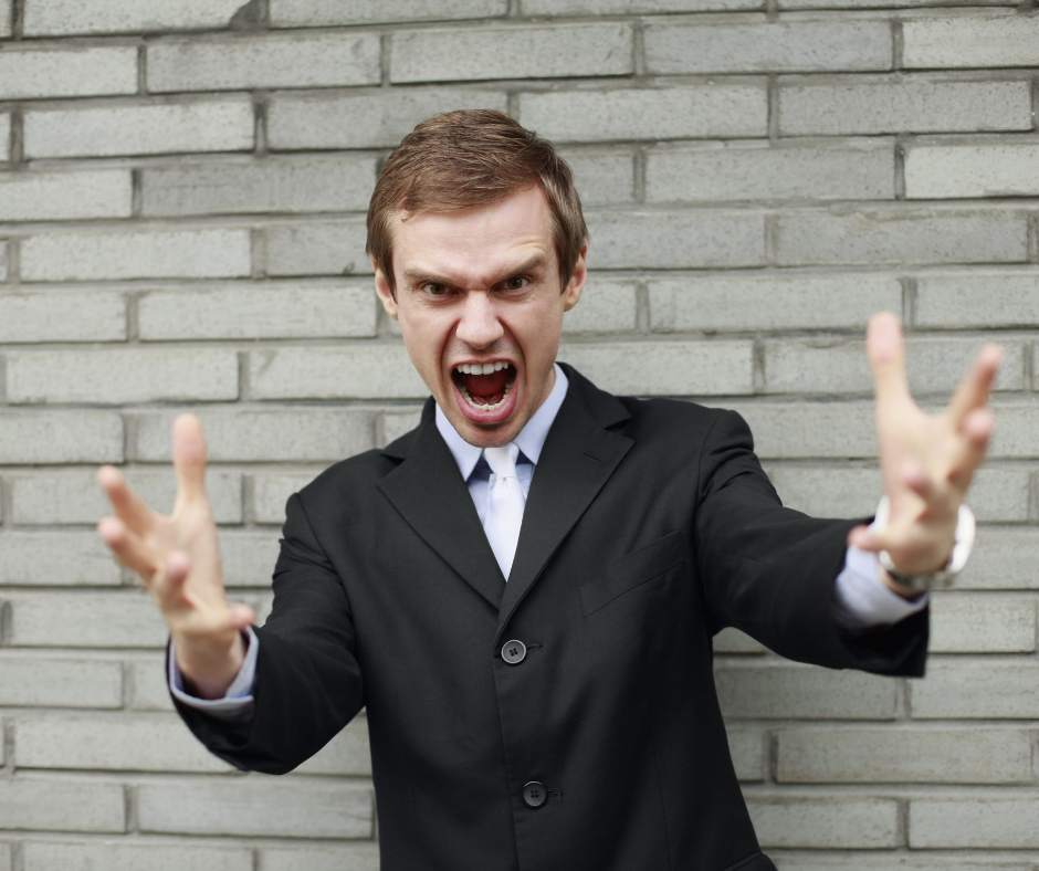 young man in suit yelling