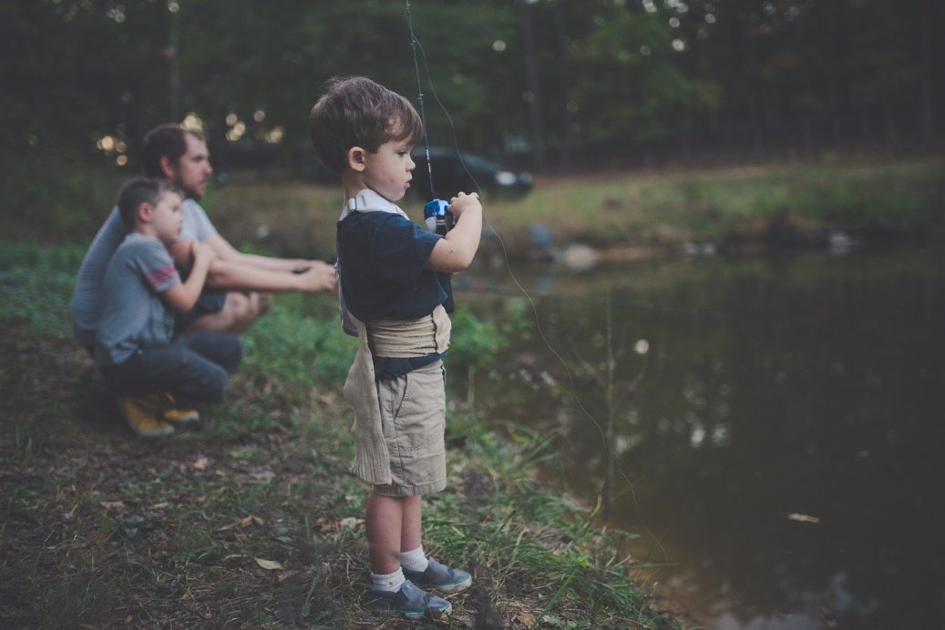 dad and young boys fishing