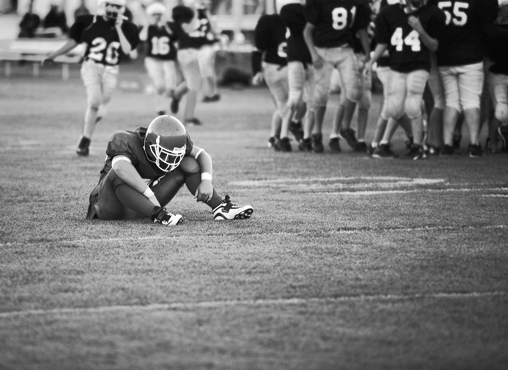 dejected football player on field