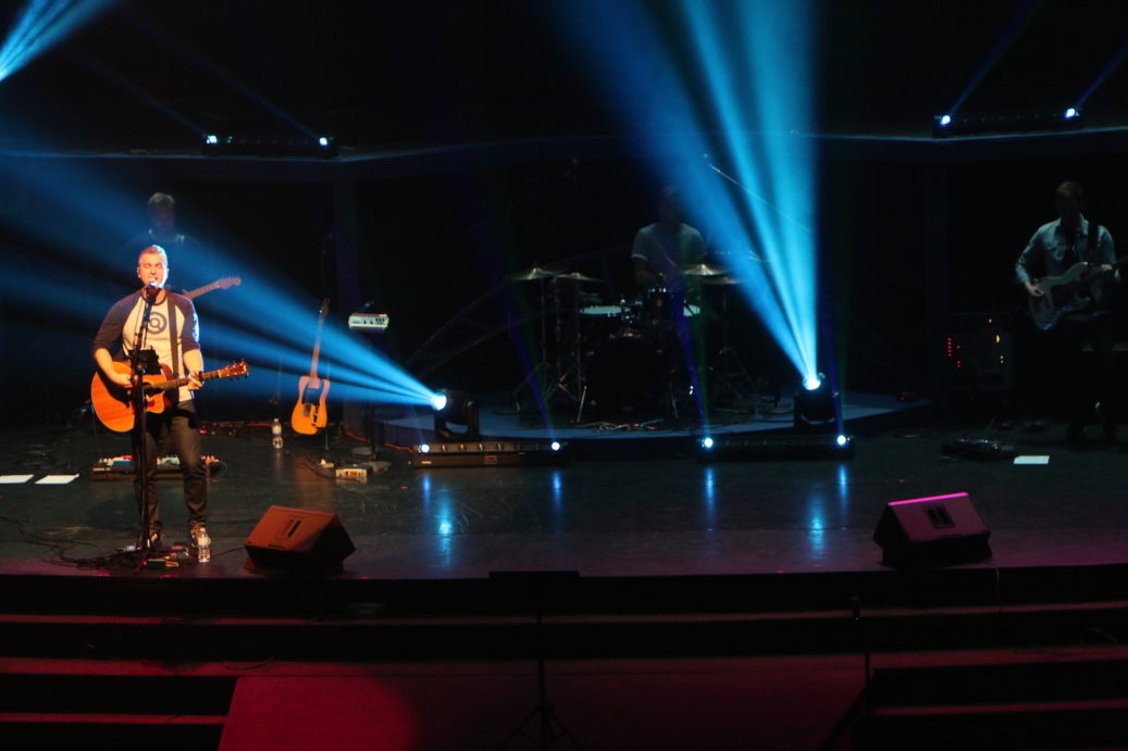 a man performing on stage in church