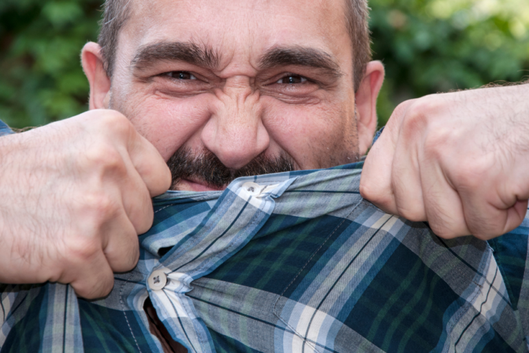 a anger man trying to tear his shirt off