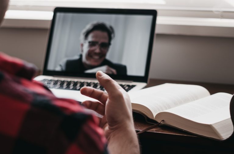 man talking during an online meeting on his laptop